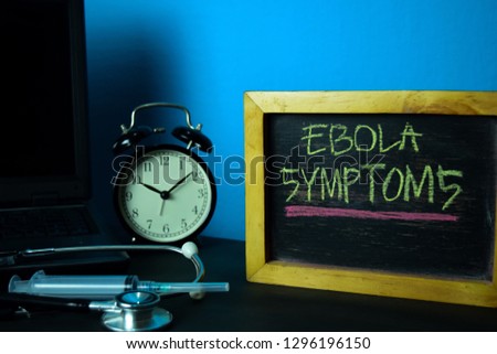 Ebola Symptoms Planning on Background of Working Table with Office Supplies. Medical and Healthcare Concept Planning on Blue Background