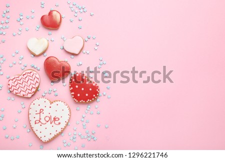 Valentine day heart shaped cookies with sprinkles on pink background