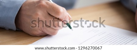 Old man close up hand hold pen sign contract put signature, make investment, taking insurance, writing will testament horizontal concept photo banner for website header design with copy space for text