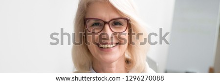 Close up portrait aged businesswoman in glasses smiling look at camera feel confident, company boss professional experienced employee concept, banner for website header design with copy space for text