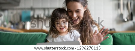 Mixed race mother and daughter using computer make video call waving hands greeting friend, having fun online modern tech applications concept banner for website header design with copy space for text