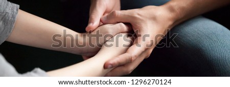 Close up man woman holds hands couple reconcile make peace after quarrel show care love empathy in relation give psychological support concept banner for website header design with copy space for text Royalty-Free Stock Photo #1296270124