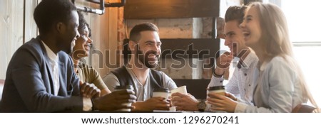 Horizontal photo happy millennial diverse friends sitting at cafe chatting having fun drink coffee enjoy time together. Multiracial friendship leisure activity concept banner for website header design