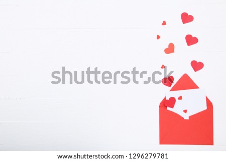 Red paper hearts with envelope on white background