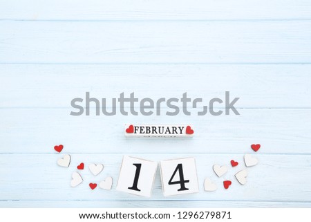Valentine day on wooden blocks with red and white hearts