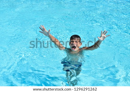 Boy drowns in the water in the pool or the sea and calls for help Royalty-Free Stock Photo #1296291262