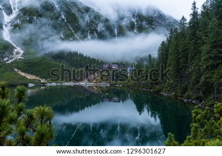wooden hut in the middle of forest with lake