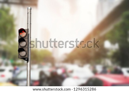 Traffic light with abstract blurred traffic jam background.