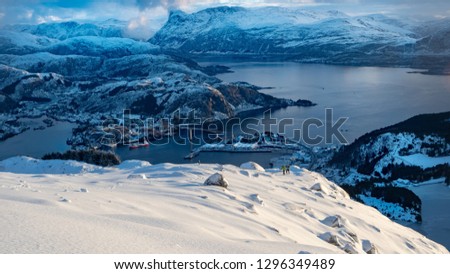 Photo taken in the western part of Norway. Two men in deep snow are climbing to the top
