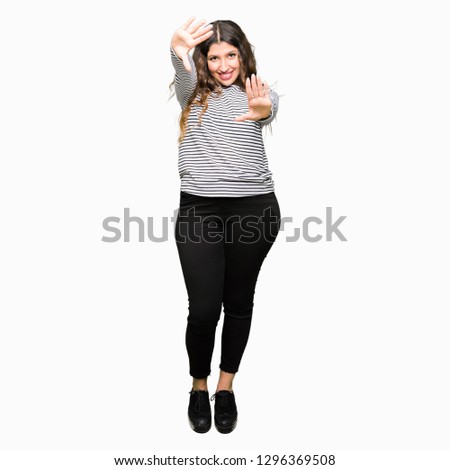 Young beautiful woman wearing stripes sweater Smiling doing frame using hands palms and fingers, camera perspective