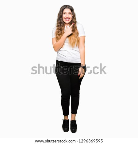 Young beautiful woman wearing casual white t-shirt cheerful with a smile of face pointing with hand and finger up to the side with happy and natural expression on face