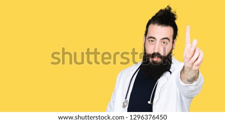 Doctor with long hair wearing medical coat and stethoscope Pointing with finger up and angry expression