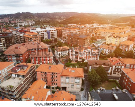 A very unique orange roofs aerial view at Bilbao, Spain with a glimpse of Sunset