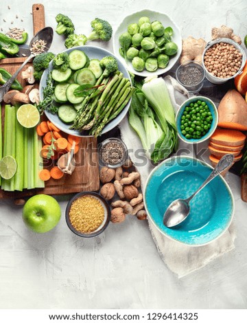 Fresh healthy vegan and vegetarian food on grey background. Diet, detox, clean eating concept. Top view