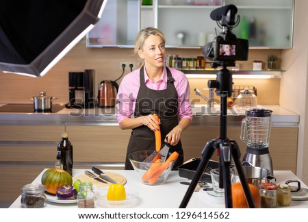 Woman making cooking vlog, recording herself on camera