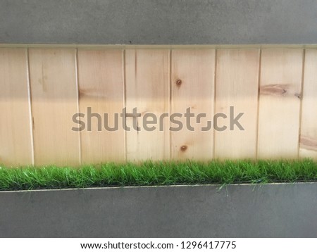 Backdrop of wooden floor with green grass