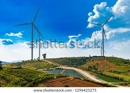 Wind turbines Geneating Clean Energy and Electricity in Blue Sky in Thailand.
