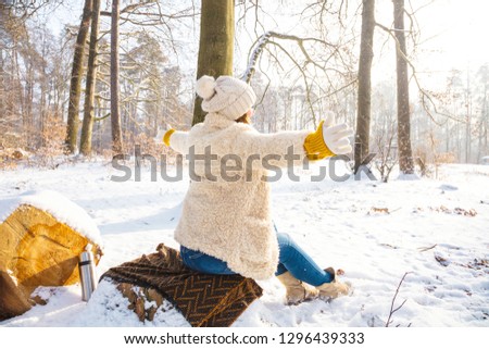 happy women in winter forest 