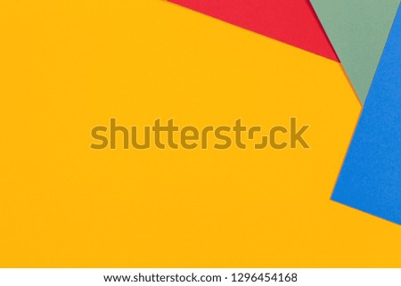 Geometric flat lay yellow green blue red color paper background