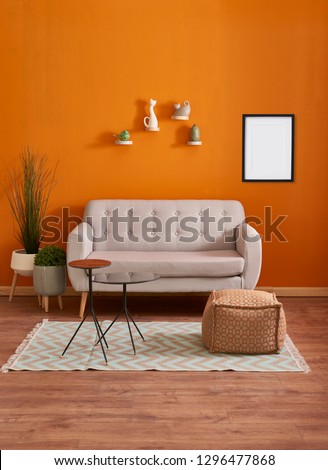 Orange room, orange wall and background, sofa, carpet and white door concept with frame and picture.