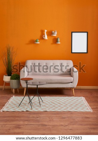 Orange room, orange wall and background, sofa, carpet and white door concept with frame and picture.