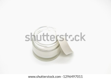 Open White Cosmetic glass jar isolated. Jar with Skin care bottles for gel, lotion, cream. White background