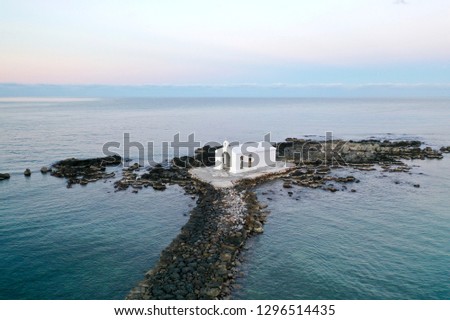 Agios Nikolaos Chapel, Georgioupoli, Crete, Greece the white chapel is built on a small rocky islet and is dedicated to Saint Nicholas, the patrons of sailors. Most famous wedding chapel aerial photos