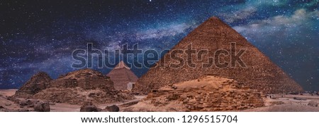 Night sky of the Milky Way over the great pyramids on the plateau of Giza, Egypt, Africa. Royalty-Free Stock Photo #1296515704