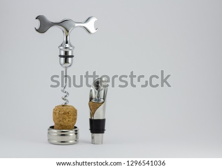 items for wine lovers a corkscrew and a funnel on a white background