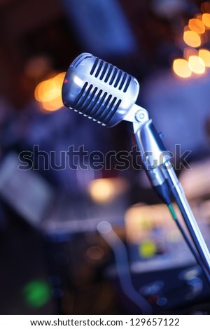 This is a vintage microphone with a DJ Table in the background. I shot this picture during a big party.