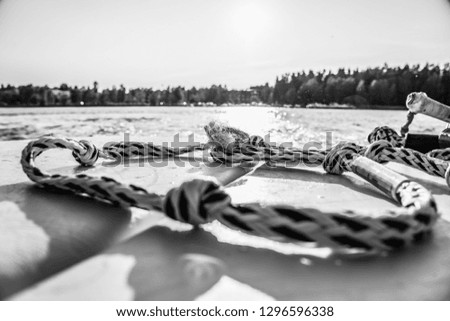 rope on the back of a boat, close up shot of a wakeboard rope, Watersport, wake boarding rope on a boat, black and white image, black and white photography