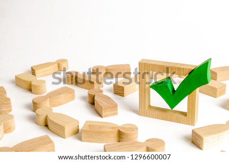 Green tick stands in the middle of the lying figures of people. Voting and election concept. Referendum, revolution. majority agreement. Peace, order, legitimization. Repression propaganda machine Royalty-Free Stock Photo #1296600007