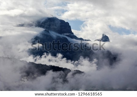 view of a mountain peak obscured by clouds