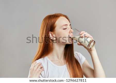 close up side view photo. woman istaking a sip of milk. healthy food