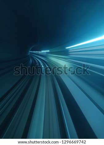 Blue motion abstract of a tunnel moving towards something.  Royalty-Free Stock Photo #1296669742