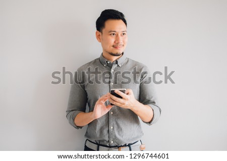 Happy smile face of handsome Asian man use smartphone. Royalty-Free Stock Photo #1296744601