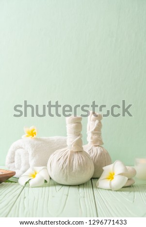 Spa herbal compressing ball with candle and orchid - beauty concept Royalty-Free Stock Photo #1296771433