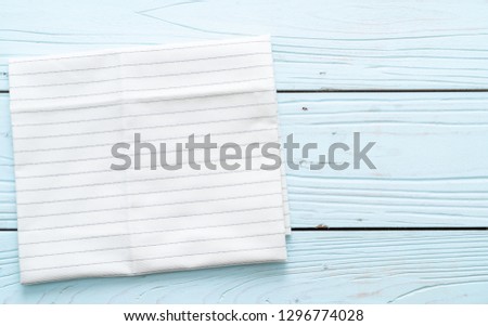 kitchen cloth (napkin) on blue wooden background with copy space