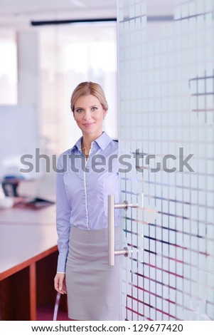 portrait of Young pretty business woman work on  notebook computer  in the bright modern office indoors