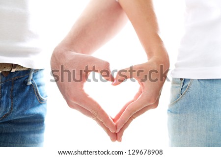 Conceptual image of female and male hands making up heart shape