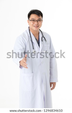 Half-length portrait of happy middle aged handsome Asian doctor, with eyeglasses, on duty at hospital stethoscope around his neck, making handshake sign, on isolated white background