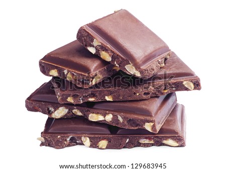 Slices of chocolate with nuts on a white background
