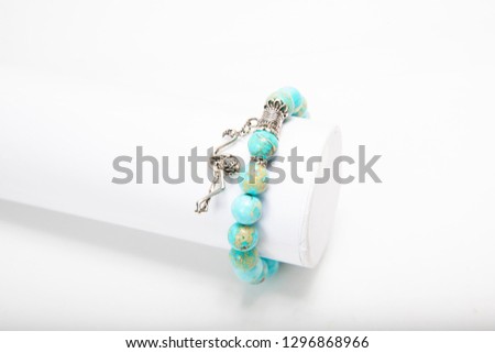 Beautiful golden bracelets and rings isolated on white/ on wood