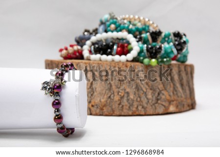 Beautiful golden bracelets and rings isolated on white/ on wood