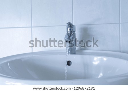 sink in bathroom with flowing water