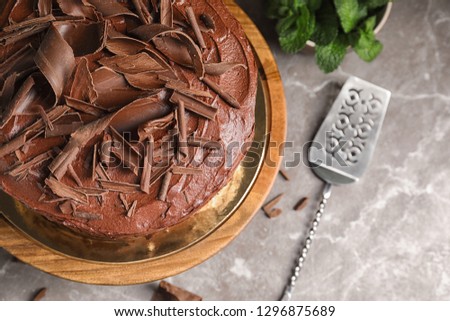 Tasty chocolate cake and shovel on table, top view. Space for text