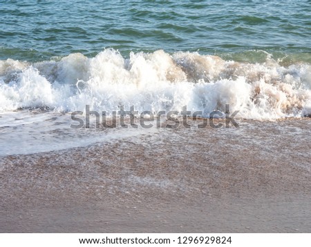 A little wave with Buble line on the beach for background.