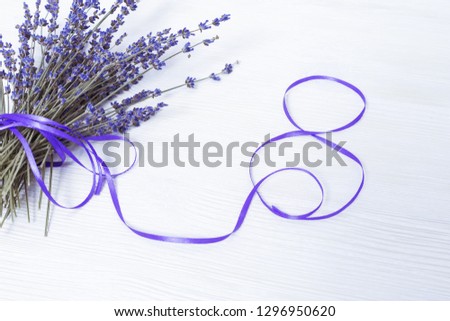 Bundle of lavender and figure eight of purple tape. Greeting card from March 8. Mother Womens Day concept. Copy space.