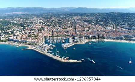 High altitude aerial picture from helicopter showing Cannes a city located on  French Riviera and host of annual Film Festival and known for its association with rich and famous
