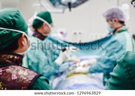 Blurred background with team surgeon at work in operating room